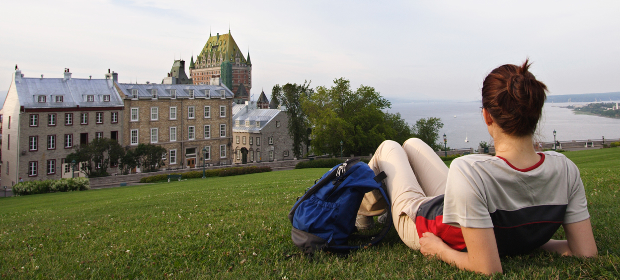 Student lying on the grass near the Chateau Frontenac