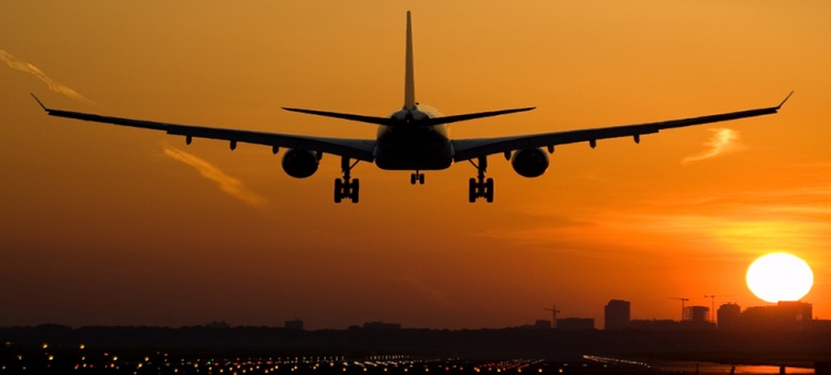 Airplane flying into the sunset